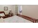 Bright bedroom with wooden bed frame, floral bedding, and a comfortable seating area at 5960 Bridge Stone Ct, Cumming, GA 30028
