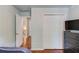View of bedroom with hardwood floors, closet and doorway to hallway with stairway at 5960 Bridge Stone Ct, Cumming, GA 30028
