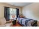 Cozy bedroom with hardwood floors, accent chair and a window view at 5960 Bridge Stone Ct, Cumming, GA 30028