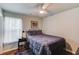 Bedroom features a ceiling fan, and a window view at 5960 Bridge Stone Ct, Cumming, GA 30028