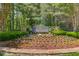 Community entrance sign surrounded by lush landscaping, creating an inviting welcome at 5960 Bridge Stone Ct, Cumming, GA 30028