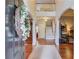 Grand foyer with hardwood floors, soaring ceilings, elegant staircase, and arched entryways at 5960 Bridge Stone Ct, Cumming, GA 30028