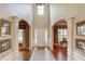 Welcoming foyer with hardwood floors, high ceilings, and decorative columns leading to living spaces at 5960 Bridge Stone Ct, Cumming, GA 30028