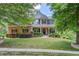 Charming two-story home with brick and stone accents, landscaped yard, and inviting front porch at 5960 Bridge Stone Ct, Cumming, GA 30028