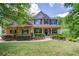 Charming two-story home with brick and stone accents, landscaped yard, and inviting front porch at 5960 Bridge Stone Ct, Cumming, GA 30028