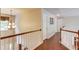 Second floor hallway with hardwood floors and white railings at 5960 Bridge Stone Ct, Cumming, GA 30028