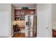 Kitchen area showcasing the stainless steel refrigerator and a small built-in desk at 5960 Bridge Stone Ct, Cumming, GA 30028