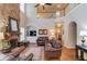 Spacious living room showcasing a stone fireplace, hardwood floors, and staircase to the upper level at 5960 Bridge Stone Ct, Cumming, GA 30028