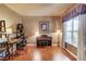 Office room featuring hardwood floors, a window with natural light, and a small piano at 5960 Bridge Stone Ct, Cumming, GA 30028