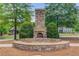 Stone outdoor fireplace with seating area, perfect for gatherings and enjoying cool evenings at 5960 Bridge Stone Ct, Cumming, GA 30028