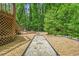 A landscaped backyard with a bocce ball court and a fire pit area, perfect for outdoor recreation and entertaining at 220 Hillswick Ct, Atlanta, GA 30328