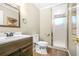 Charming bathroom featuring a wood vanity, toilet, and a shower with a glass door at 220 Hillswick Ct, Atlanta, GA 30328