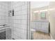 Elegant bathroom featuring white cabinets, double sinks, and a luxurious tiled shower with glass door at 220 Hillswick Ct, Atlanta, GA 30328