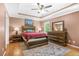 Bedroom with a tray ceiling, fan, and furniture set at 220 Hillswick Ct, Atlanta, GA 30328