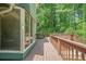 Large wooden deck ideal for outdoor entertaining, accessible from the sunroom with lush views of the yard at 220 Hillswick Ct, Atlanta, GA 30328