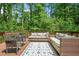 Inviting deck with outdoor seating, perfect for relaxing and enjoying the serene, wooded surroundings at 220 Hillswick Ct, Atlanta, GA 30328