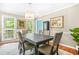 Inviting dining room with a stylish chandelier, large windows, and wood floors, perfect for entertaining at 220 Hillswick Ct, Atlanta, GA 30328