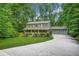Beautiful two-story home with a well-manicured lawn and an ample driveway nestled in a lush, green environment at 220 Hillswick Ct, Atlanta, GA 30328
