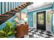 Stylish foyer with a black-and-white checkered floor, a staircase, and an elegant cabinet with a bust statue at 220 Hillswick Ct, Atlanta, GA 30328