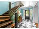Inviting foyer with black-and-white checkered floors, staircase, and a classic console table, offering a welcoming entry at 220 Hillswick Ct, Atlanta, GA 30328