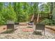 Outdoor patio featuring brick accents, built in fire pit, wicker seating, and a bocce ball court at 220 Hillswick Ct, Atlanta, GA 30328