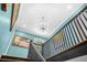 Elegant staircase with black railing and a chandelier at 220 Hillswick Ct, Atlanta, GA 30328