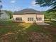 Well-maintained backyard featuring a home with large windows and a concrete patio at 30 Trelawney Ct, Covington, GA 30016
