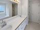 Bathroom boasts double sink vanity with a large mirror and natural light at 30 Trelawney Ct, Covington, GA 30016