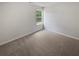 Cozy bedroom featuring neutral walls, carpet flooring, and a window at 30 Trelawney Ct, Covington, GA 30016