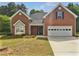 Charming brick home featuring a two-car garage and well-maintained front yard at 30 Trelawney Ct, Covington, GA 30016