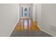 Hallway view featuring hardwood flooring and a decorative front door at 30 Trelawney Ct, Covington, GA 30016