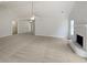 Spacious living room featuring neutral walls, fireplace, and a vaulted ceiling at 30 Trelawney Ct, Covington, GA 30016