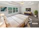 Comfortable main bedroom with a tray ceiling, soft carpet, and natural light at 30 Trelawney Ct, Covington, GA 30016