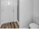 Small bathroom features white door, shower and toilet at 3037 Bonnes Dr, Lithonia, GA 30038