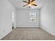 Bright bedroom features neutral carpet and walls with a view of the outdoors at 3037 Bonnes Dr, Lithonia, GA 30038
