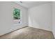 Cozy bedroom with neutral carpet and view from window at 3037 Bonnes Dr, Lithonia, GA 30038