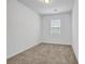 Bedroom with window and neutral carpet, bright interior at 3037 Bonnes Dr, Lithonia, GA 30038
