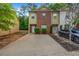 Charming townhome featuring brick and siding facade, driveway, and well-maintained landscaping at 3037 Bonnes Dr, Lithonia, GA 30038