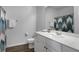 Clean bathroom with white cabinets, a large mirror, and a stylish shower curtain, blending functionality and design at 3982 Carver Cir, Doraville, GA 30360