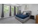 Serene bedroom with natural light, large windows, and a cozy bed with a tufted headboard at 3982 Carver Cir, Doraville, GA 30360