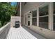 This outdoor deck has white wood flooring and railings with a grill for outside cooking at 3982 Carver Cir, Doraville, GA 30360