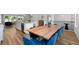 Open-concept layout with a dining area featuring a large wooden table and comfortable blue chairs, connected to kitchen at 3982 Carver Cir, Doraville, GA 30360