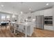 Modern kitchen featuring an island with bar stools, stainless steel appliances, and white cabinets and countertops at 3982 Carver Cir, Doraville, GA 30360