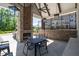 A covered outdoor kitchen and dining area featuring a fireplace and seating for entertaining at 3982 Carver Cir, Doraville, GA 30360