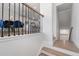 Modern staircase with wood treads, iron railings, and neutral walls leading to the dining room and kitchen at 3982 Carver Cir, Doraville, GA 30360