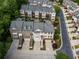 Aerial view of townhomes with driveways and manicured landscaping near trees at 4306 Laurel Creek Se Ct, Smyrna, GA 30080