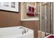 Bathroom featuring a tub and separate glass shower with a dark accent wall at 4306 Laurel Creek Se Ct, Smyrna, GA 30080