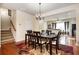 A bright dining room with hardwood floors sits adjacent to a staircase and an open kitchen at 4306 Laurel Creek Se Ct, Smyrna, GA 30080