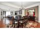A dining room with hardwood floors leads to an open kitchen with stainless steel appliances and granite countertops at 4306 Laurel Creek Se Ct, Smyrna, GA 30080