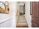 Welcoming foyer featuring a staircase, neutral walls with wainscoting, and a stylish mirror at 4306 Laurel Creek Se Ct, Smyrna, GA 30080